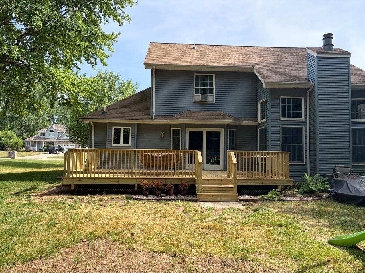 New pressure-treated deck with railing and stairs