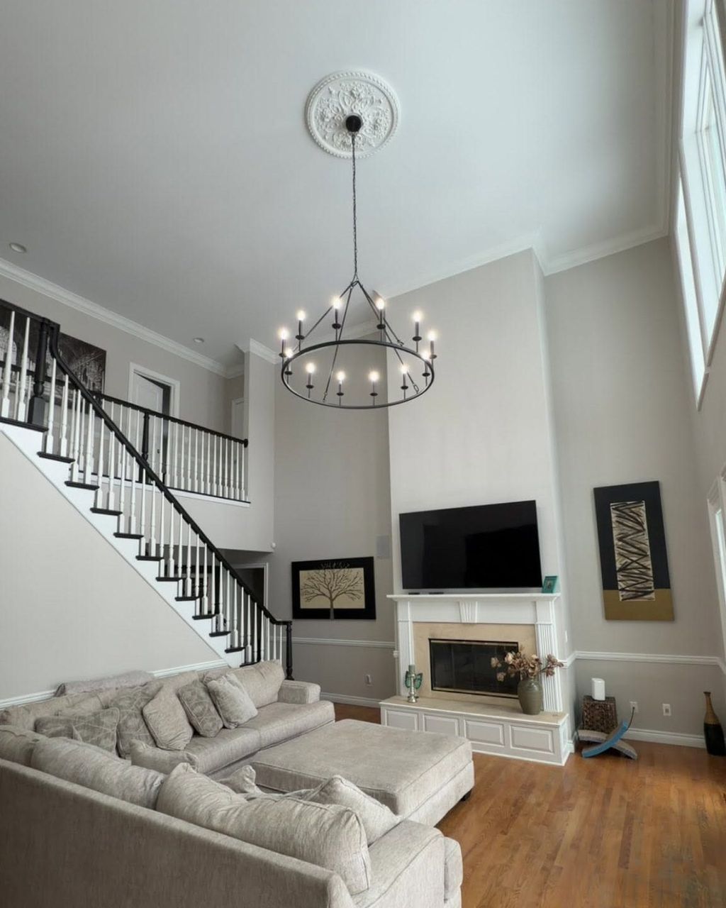 Finished two-story great room with a new chandelier