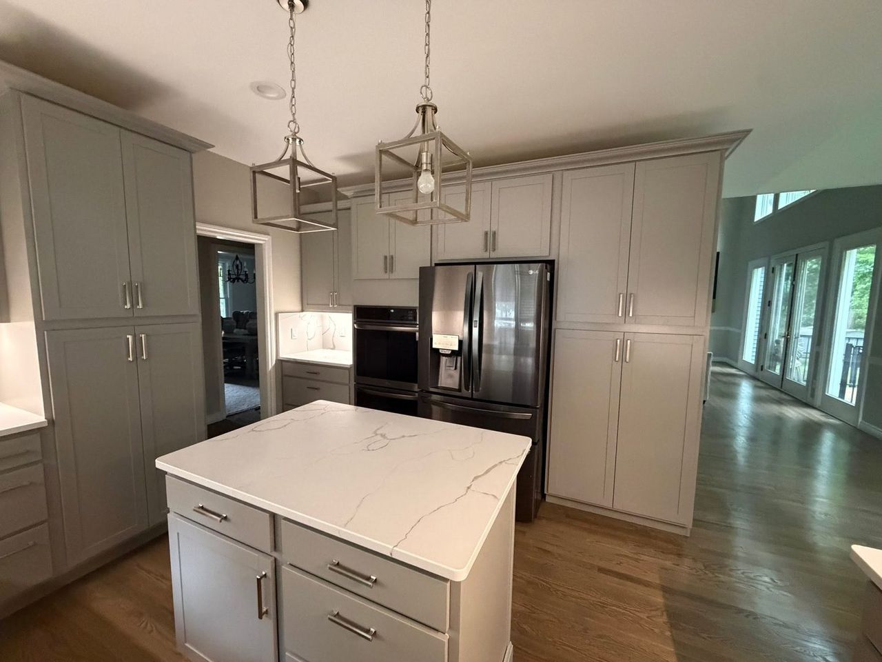 Kitchen after remodeling, with floor-to-ceiling pantry cabinets and wall ovens