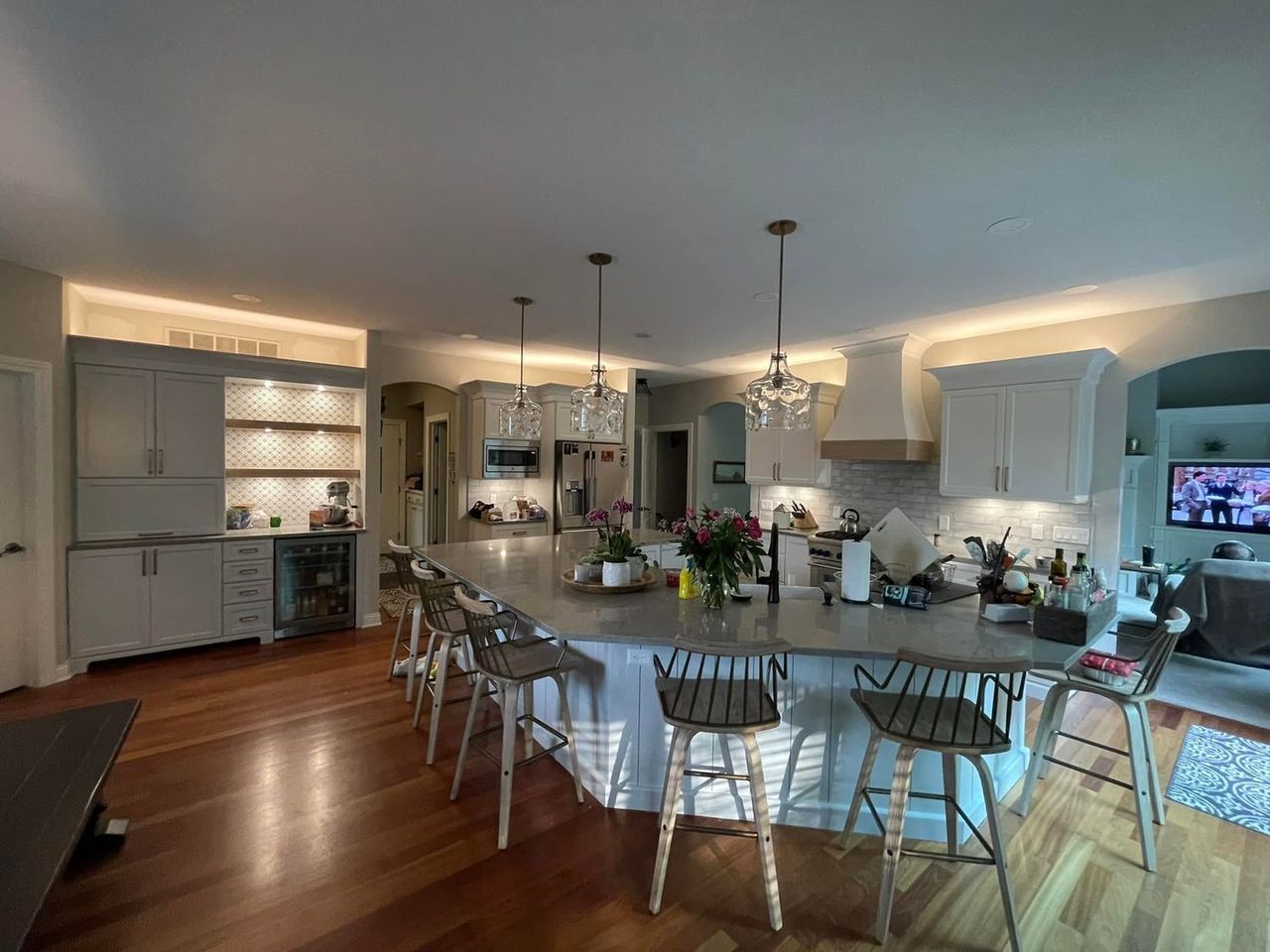 Finished kitchen with painted cabinets, island seating and walnut counter