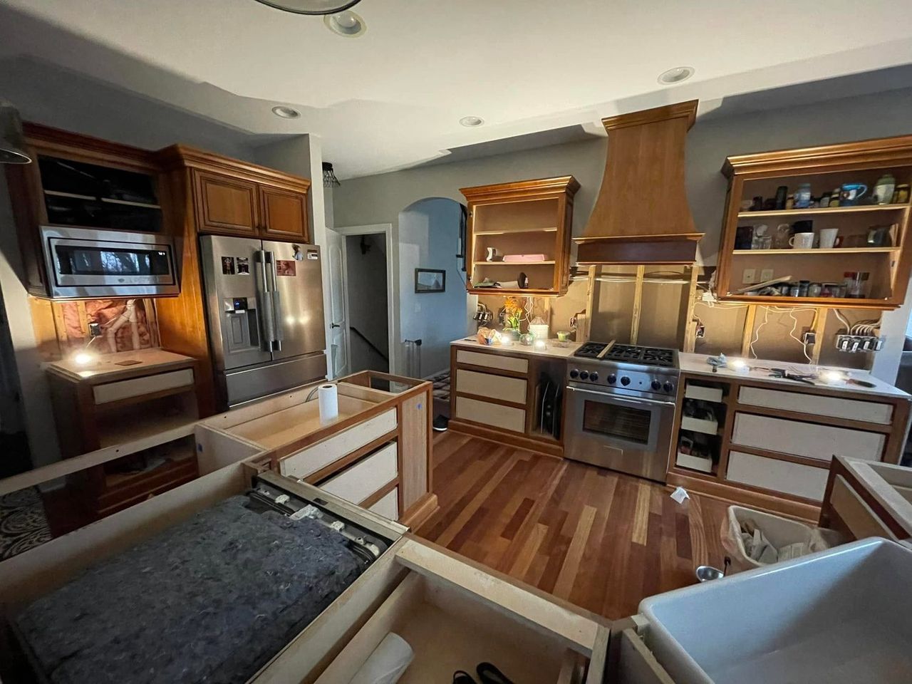 Kitchen during demolition, old wood cabinets partially removed