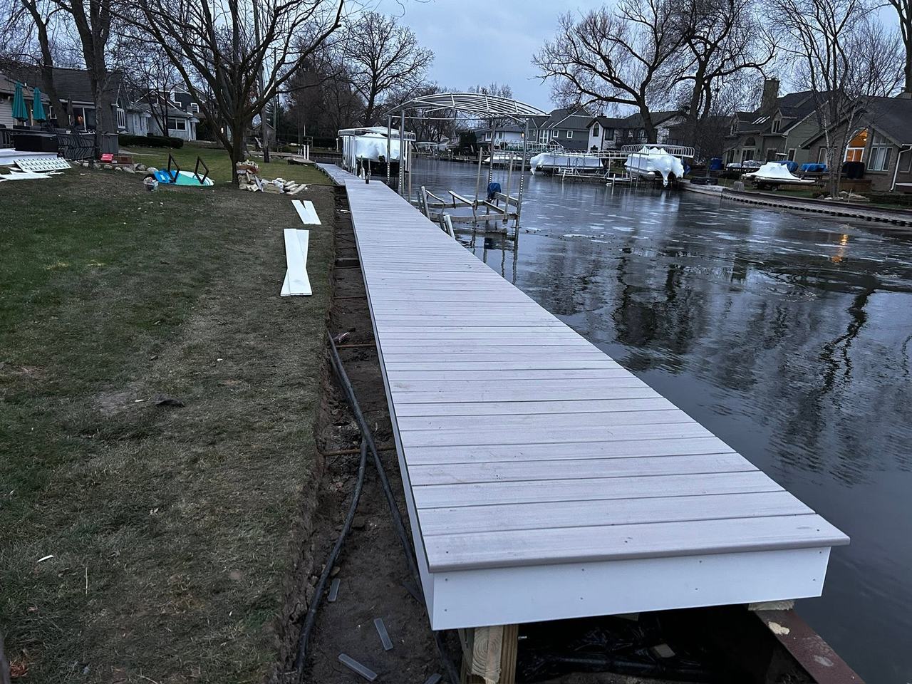 Finished composite walkway running along the shoreline at dusk